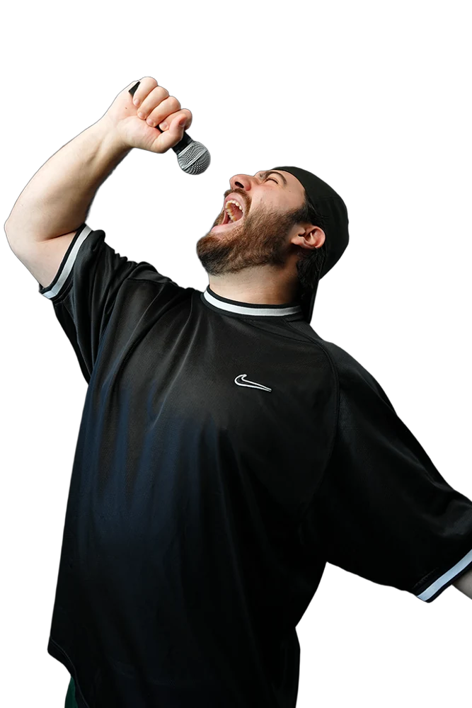 Shawn Chidiac as Kooya Darwin, singing into a microphone